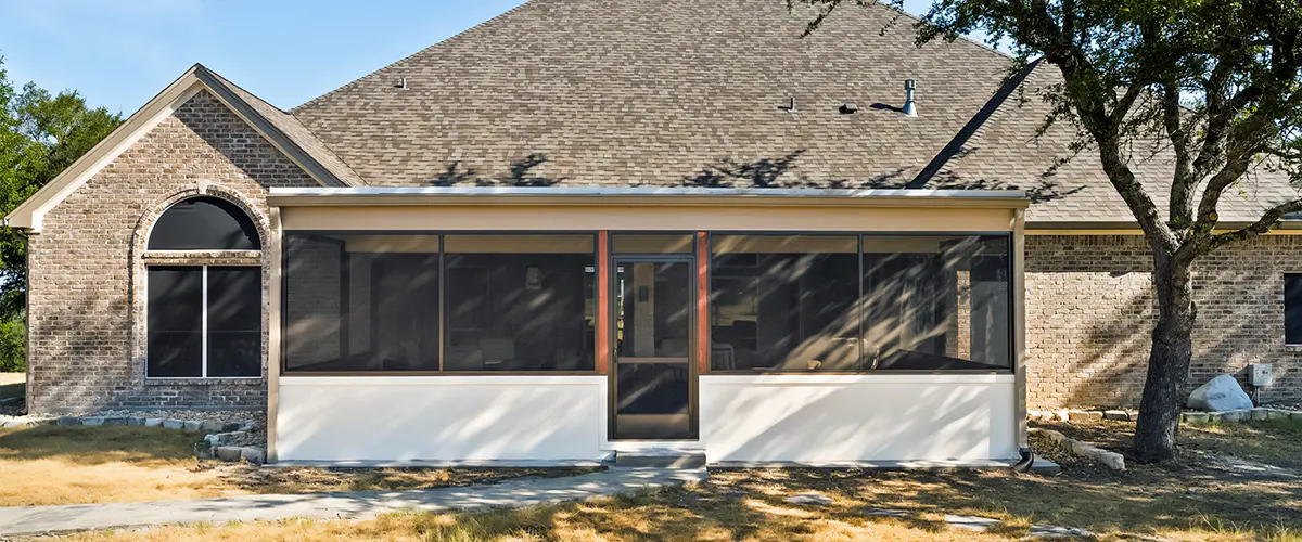 Enclosed patio with a durable frame and mesh panels, enhancing outdoor living while providing shade and bug protection.