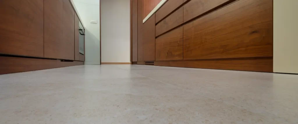 Modern kitchen with warm wood cabinets and beige tiled flooring