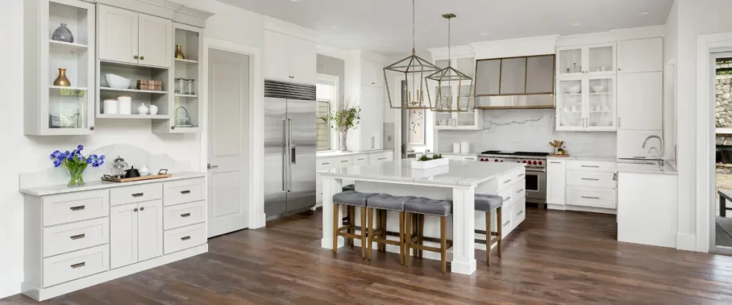 Modern kitchen with a large wood island, black and wood cabinetry, and stainless steel appliances