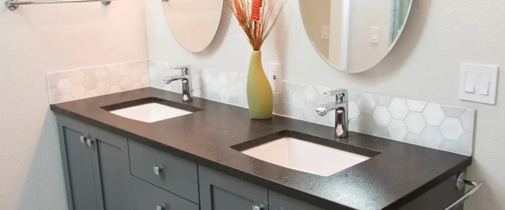 Modern bathroom with a dark countertop and hexagonal tile backsplash