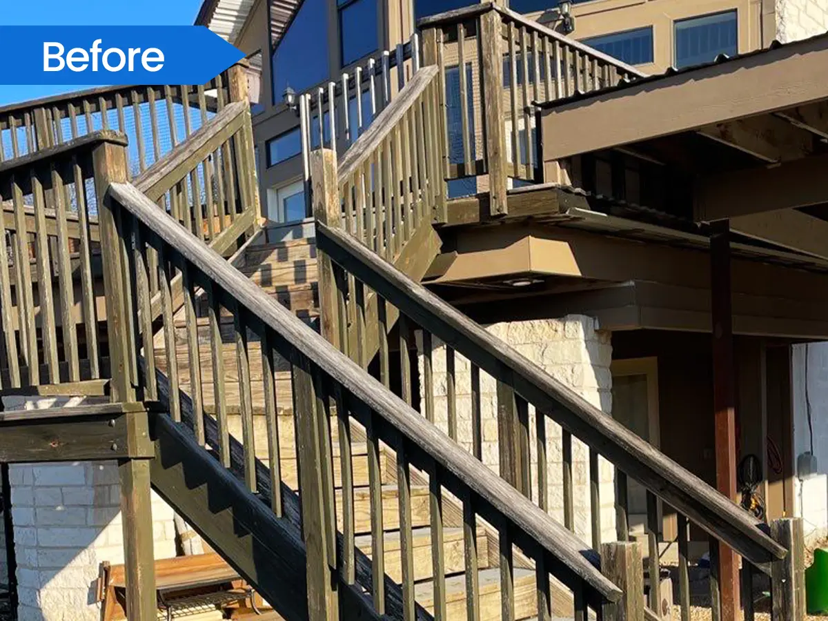 Close-up view of a wooden staircase railing leading to an elevated deck before re-build