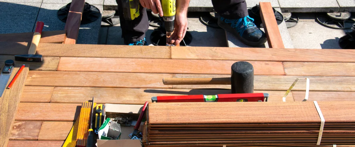 Deck installation with power tools and wooden planks