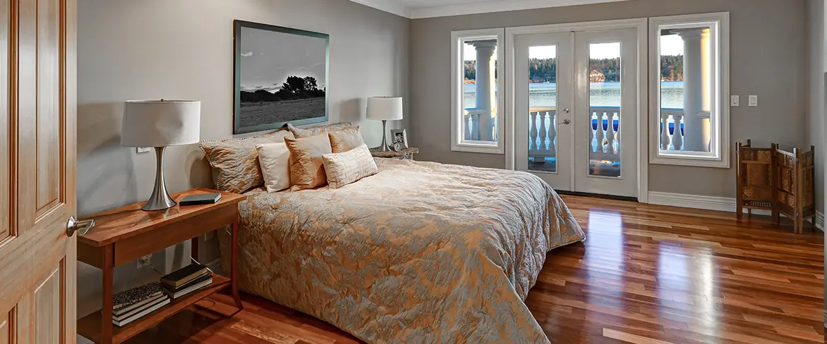 Cozy bedroom with large windows and lake view