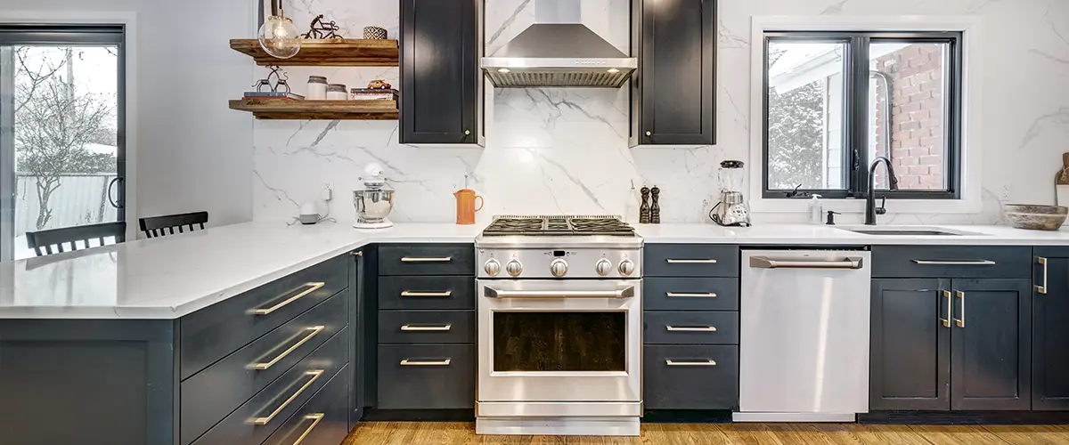 Kitchen remodel featuring black cabinets and stainless steel appliances