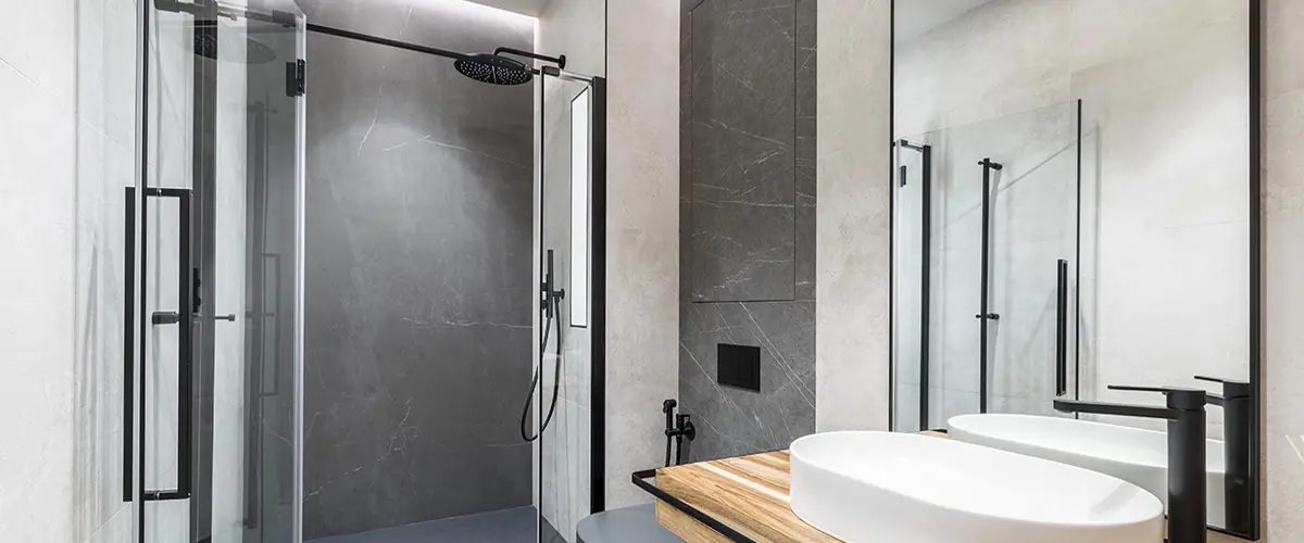 Sleek black and white shower remodel with dual glass doors