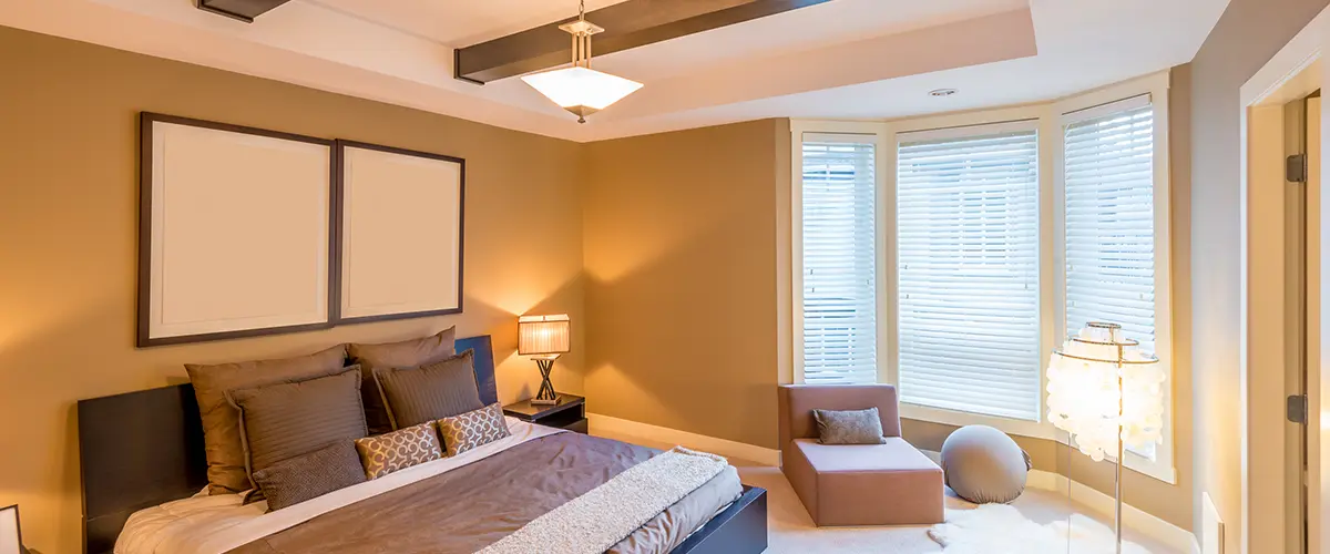 Modern bedroom with bay window and cozy seating area