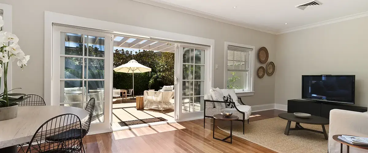 Bright living room with sliding doors opening to a sunny patio
