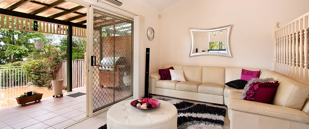 Cozy living room with sliding screen door to covered patio