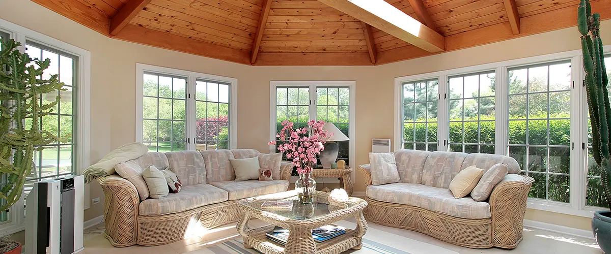 Sunroom with wicker furniture and wooden ceiling beams