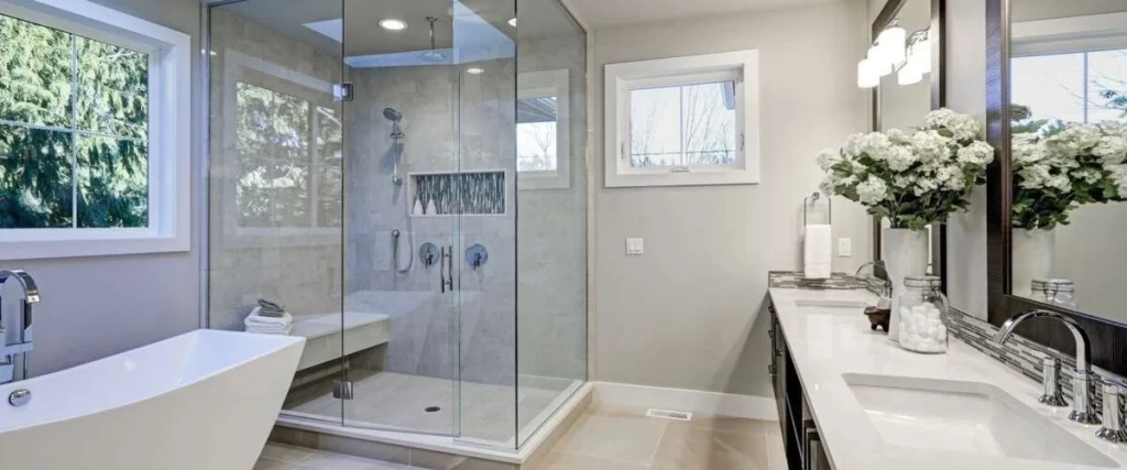 A contemporary bathroom featuring a freestanding tub and a large glass-enclosed walk-in shower with a tiled bench and separate windows for natural light.