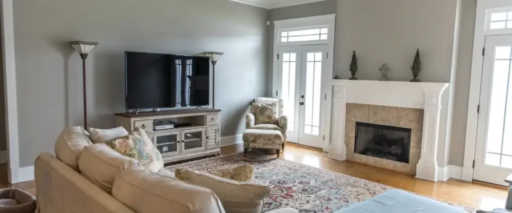 Cozy living room with neutral tones, modern fireplace, and classic furniture arrangement.