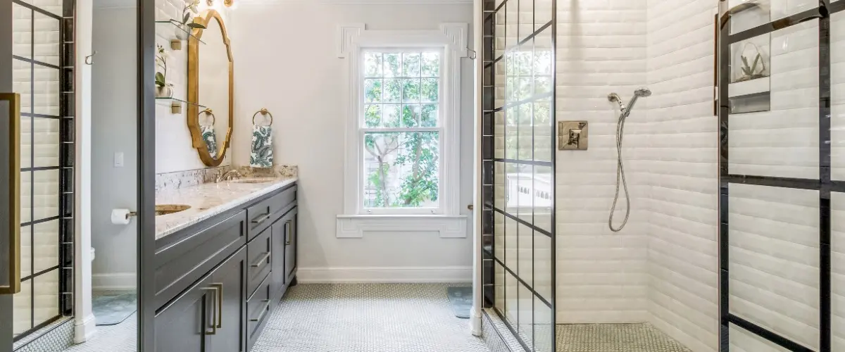A modern bathroom featuring a glass shower door and a spacious walk-in shower