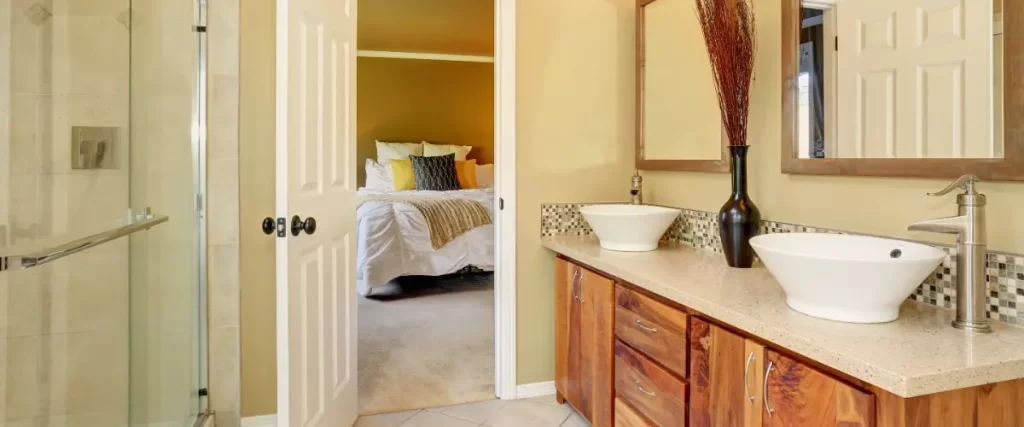 A modern bathroom featuring two sinks and a spacious walk-in shower.
