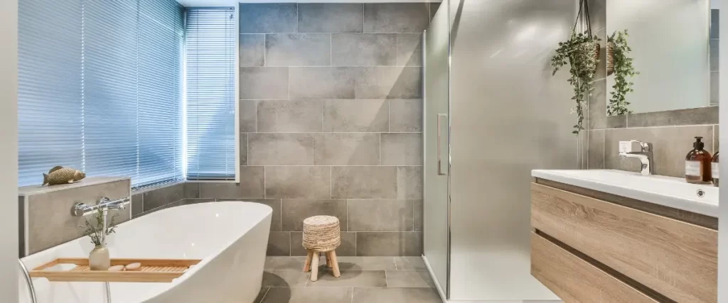 Modern bathroom featuring a sleek tub and a stylish sink, with contemporary design elements and neutral colors.