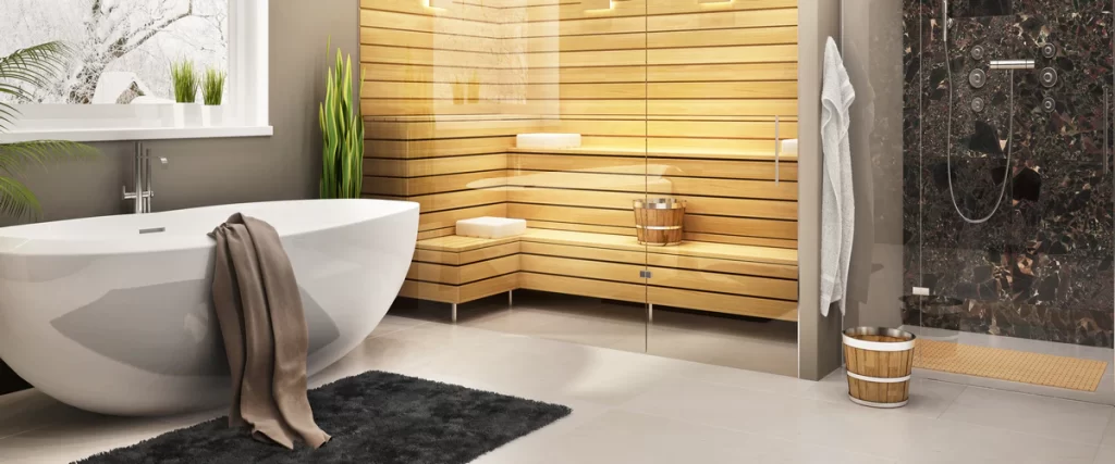 A luxury spa-style bathroom featuring a modern freestanding tub next to a glass-enclosed wooden sauna.