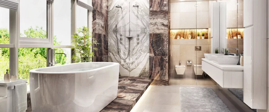 A bright, luxury finished bathroom featuring book-matched marble walls, a large freestanding soaking tub by the window, and a modern white double vanity.