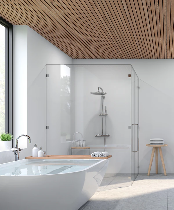 Modern bathroom remodeling in Fort Hood, TX featuring a white freestanding bathtub with a wooden tray, a sleek glass-enclosed walk-in shower, and a custom wood slatted ceiling.