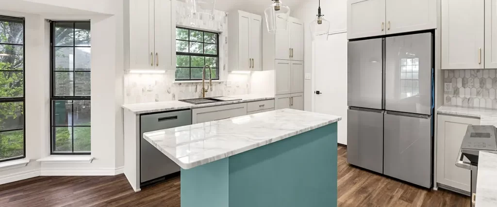 Modern white kitchen remodel with marble island, custom cabinets, and pendant lighting