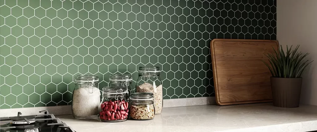 Green hexagon tile kitchen backsplash with open shelving and modern countertop design