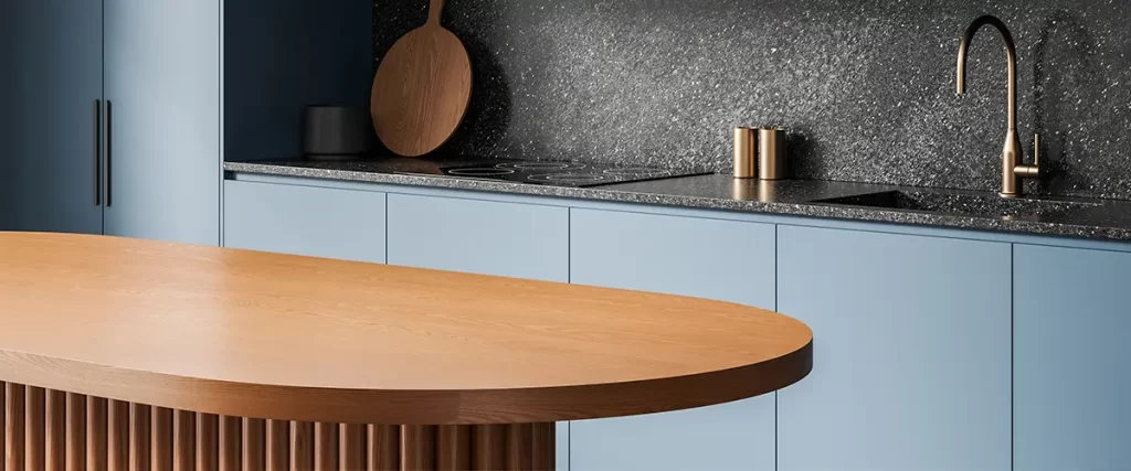 Modern blue kitchen remodel with custom cabinetry, stone backsplash, and wood island countertop