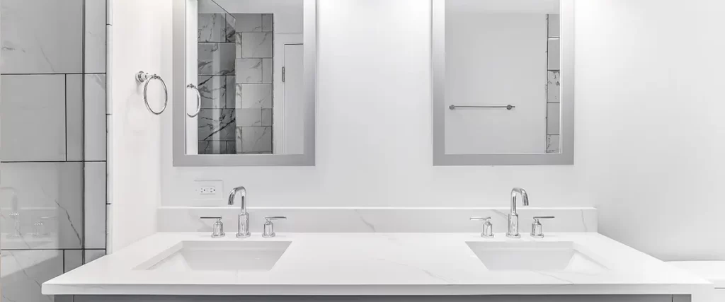 Modern double vanity bathroom remodel with quartz countertop, framed mirrors, and dual sinks