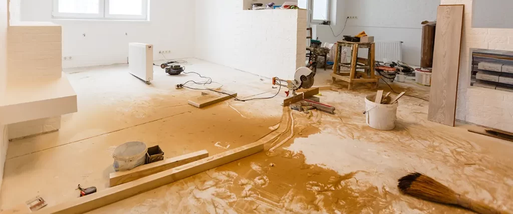 Open concept home renovation in progress with flooring installation, trim work, and interior remodeling.