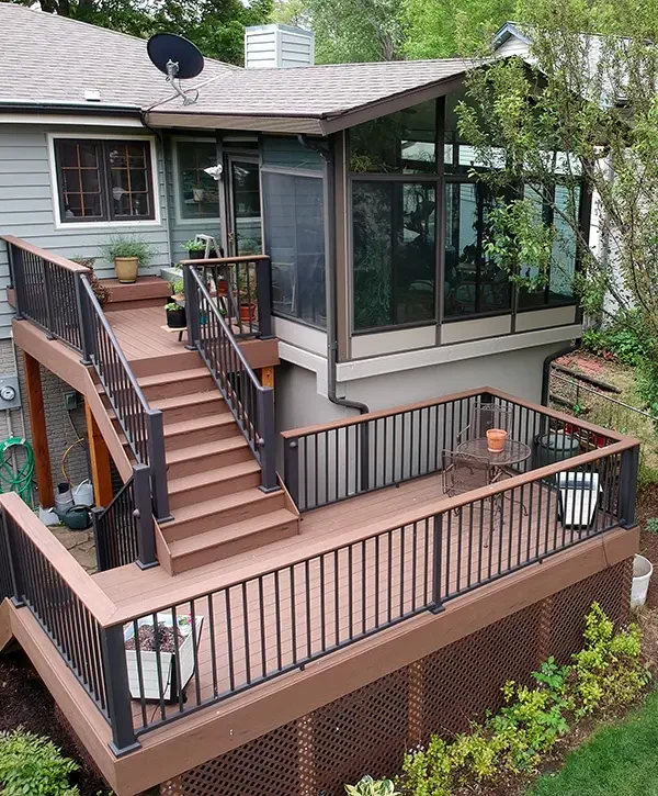 Custom backyard deck with railing and outdoor seating
