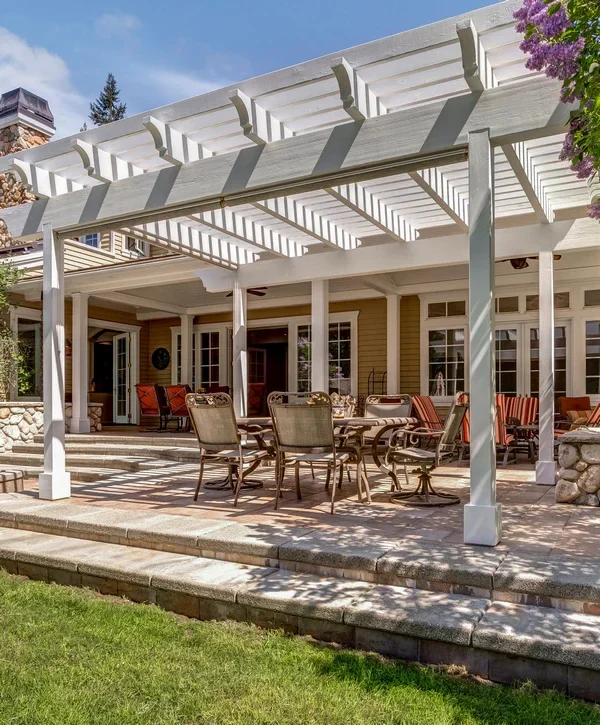 White pergola over a patio dining space for outdoor living