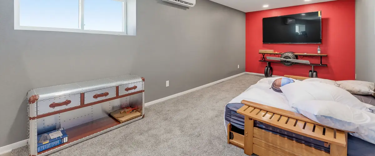 Finished home addition bedroom with modern lighting, mini-split AC and entertainment area