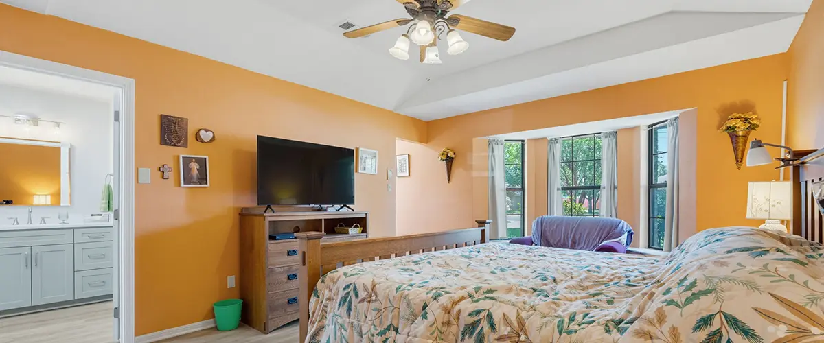 Spacious bedroom home addition with vaulted ceiling, large windows and adjoining bathroom